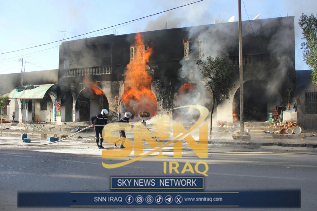 Firefighters combat a large blaze in an urban area, Médenine, Tunisia.