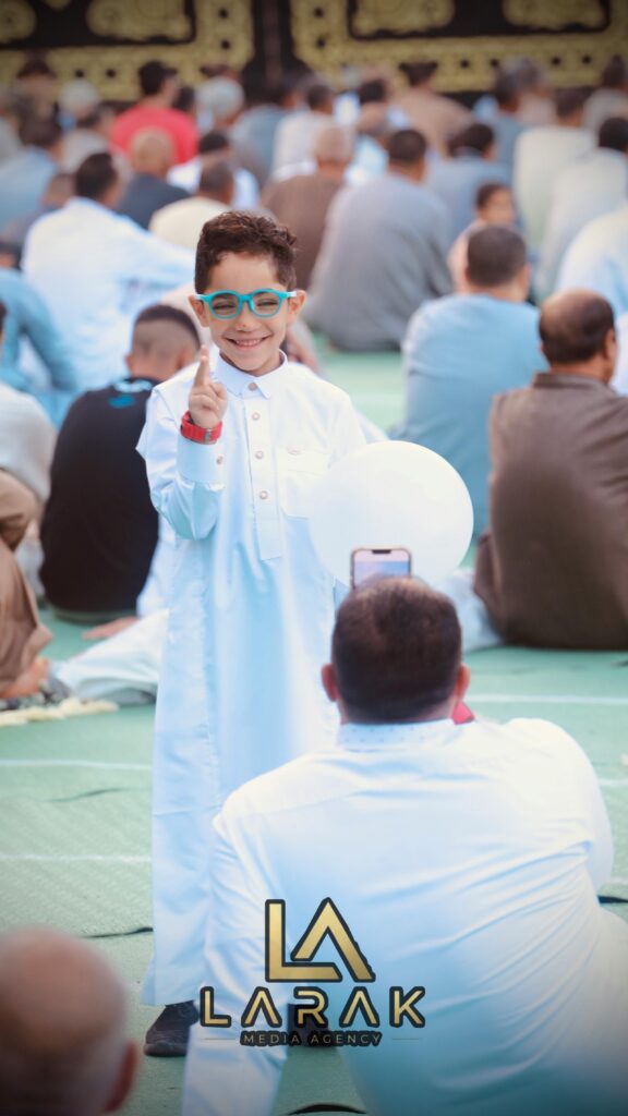 A happy child celebrating Eid with a balloon at a gathering in Cairo, Egypt.