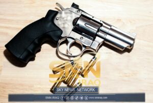 Silver revolver and bullets on a wooden surface illustrating security themes.
