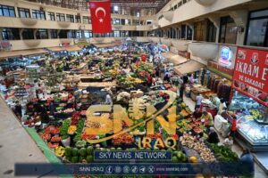 Colorful aerial view of vibrant stalls in a crowded Turkish indoor market.