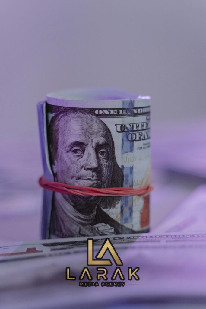 Close-up image of a rolled US dollar bill secured with a rubber band, creating an abstract financial concept.