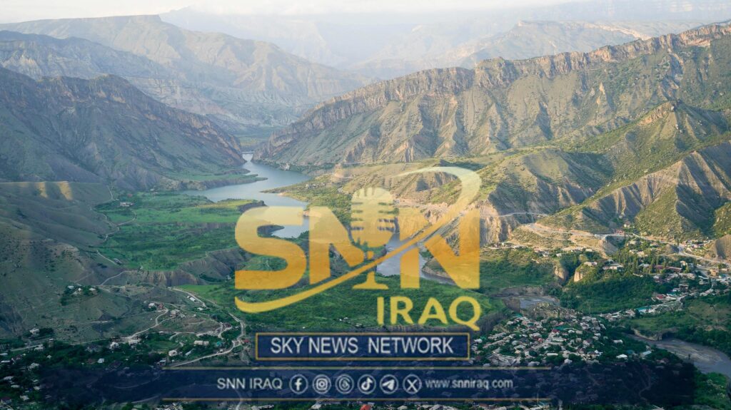 Experience the stunning aerial view of a serene river winding through majestic mountains.