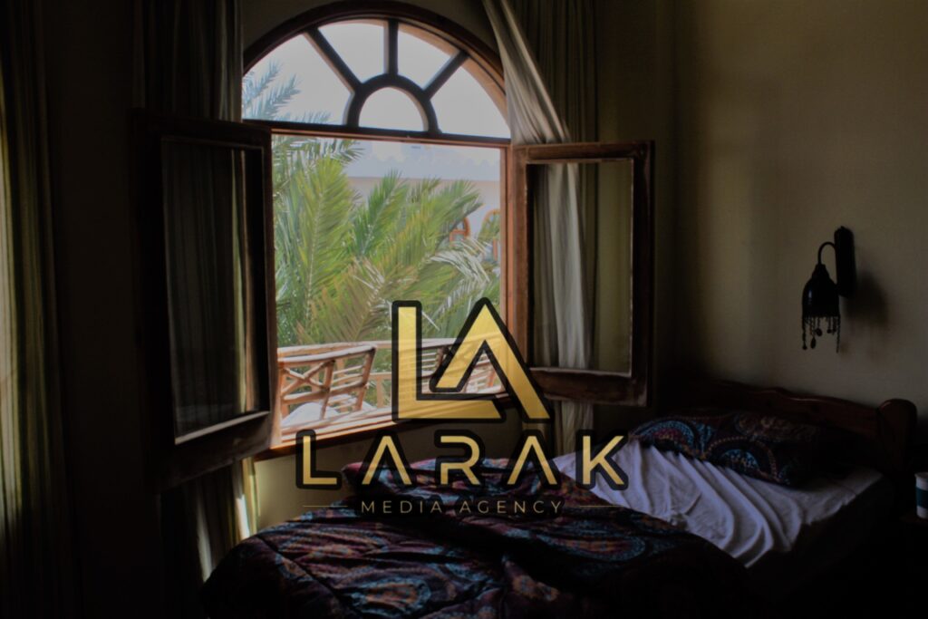Inviting bedroom with open window and palm tree view in Giza, Egypt.