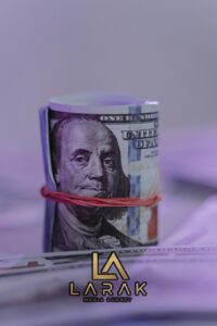 Close-up image of a rolled US dollar bill secured with a rubber band, creating an abstract financial concept.